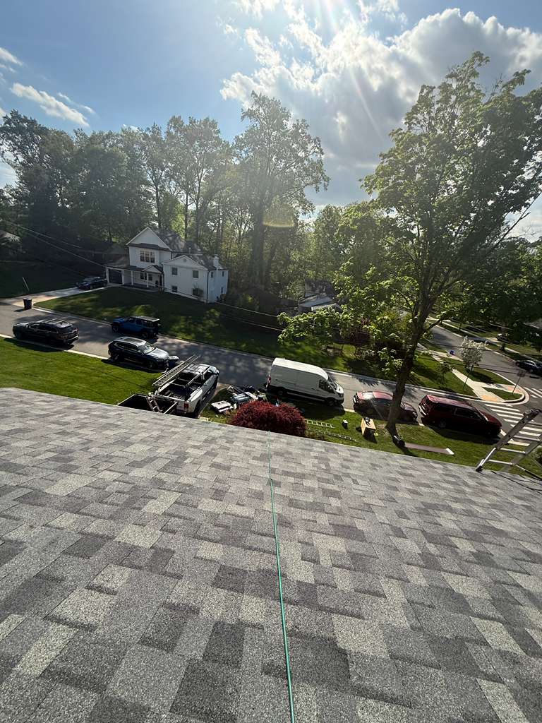 Roofer installing shingles
